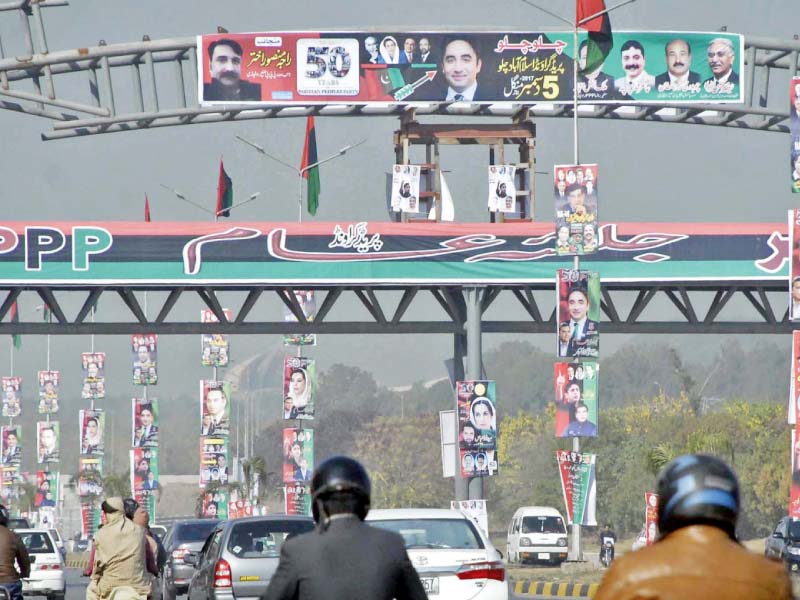 islamabad highway covered with ppp flags and banners on the eve of party s public meeting at the parade ground photo online
