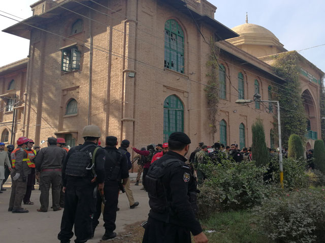 police and rescue workers stand outside the directorate of agriculture institute in peshawar on december 1 2017 photo reuters