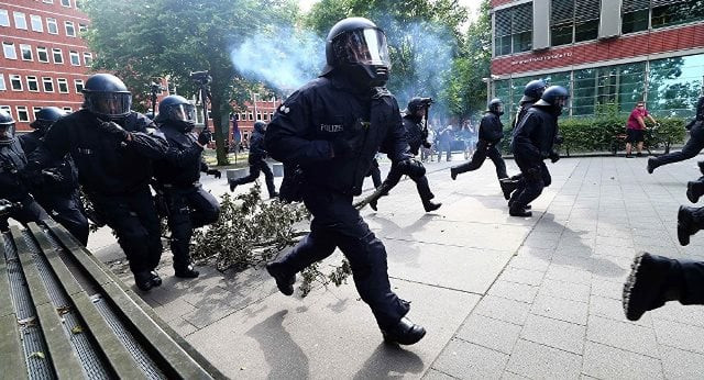 police said officers were searching properties of the anti capitalist group known as the black bloc photo reuters police said officers were searching properties of the anti capitalist group known as the black bloc photo reuters