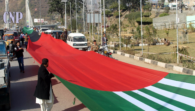 ajk ppp workers carrying the long flag to parade ground photo express