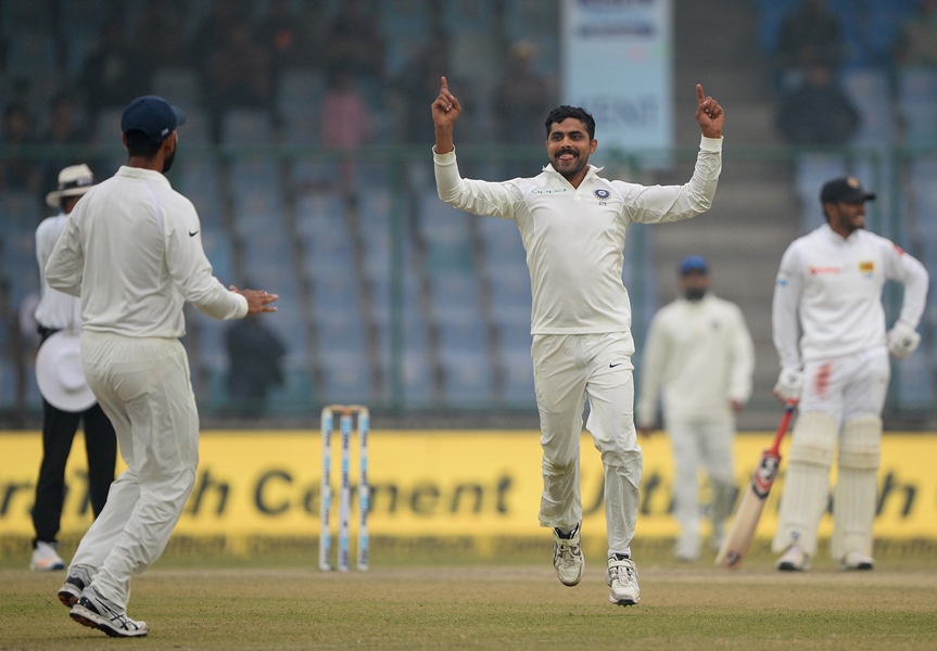 indian bowler ravindra jadeja c celebrates the dismissal of sri lankan batsman dimuth karunarathna with teammate cheteshwar pujara during the fourth day of third test cricket match between india and sri lanka at the feroz shah kotla cricket stadium in new delhi on december 5 2017 photo afp