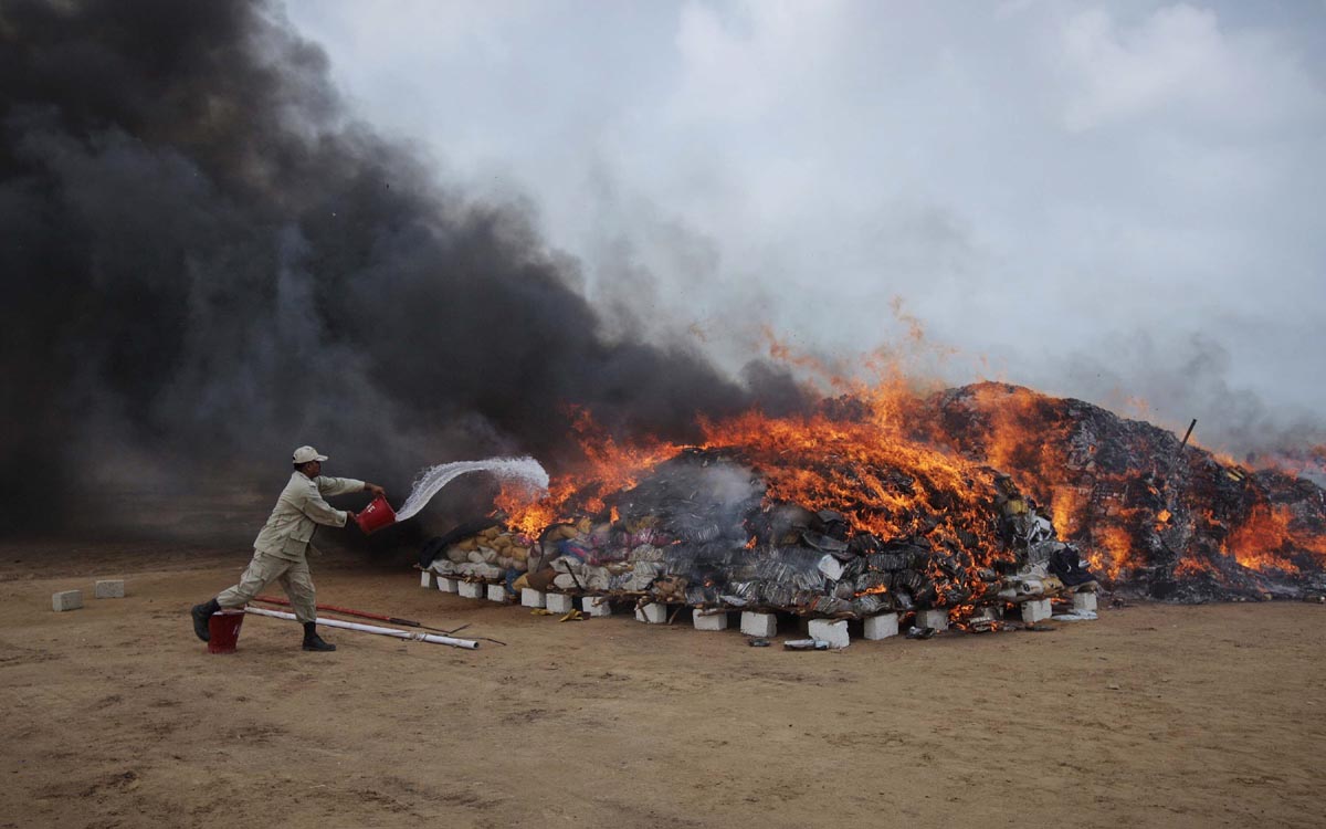 file photo a coast guard officer pours kerosene oil on a burning pile of confiscated hashish and bags of betel nuts during a campaign to mark the international day against drug abuse and illicit trafficking on the outskirts of karachi june 26 2012 photo reuters