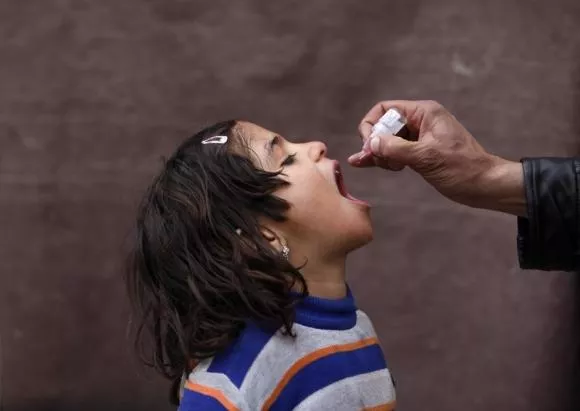 child receives polio vaccination drops photo reuters child receives polio vaccination drops photo reuters