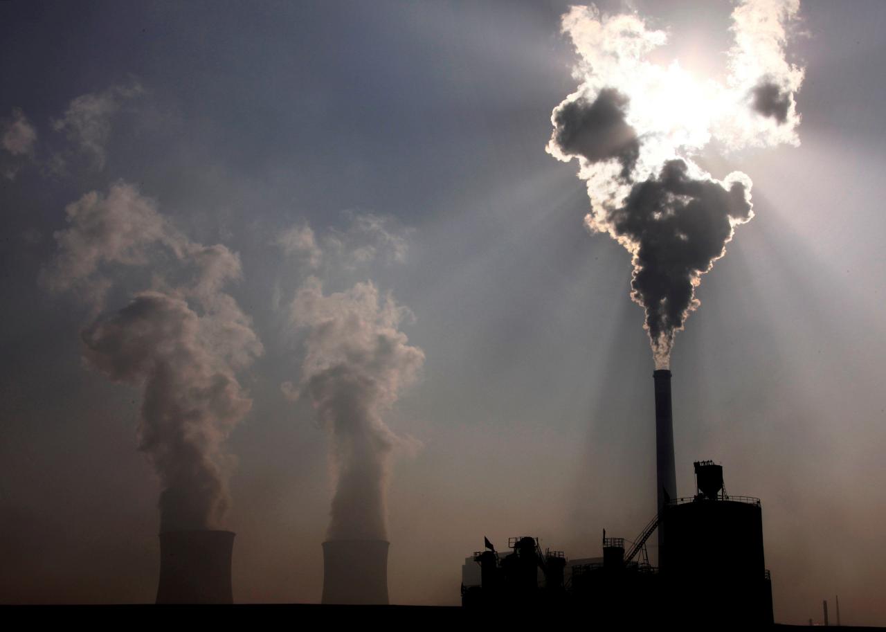 a power plant can be seen behind a factory photo reuters file