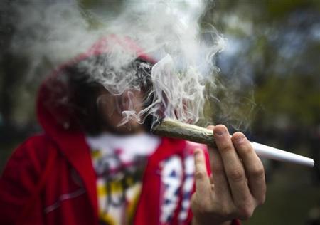 a man smokes a large joint before the global marijuana march in toronto photo quot reuters