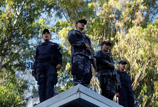 police officers stand guard at the headquarters of honduras 039 elite police force after an agreement with the government not to crack down on demonstrators in the marches over a contested presidential election according to local media in tegucigalpa honduras december 5 2017 photo reuters