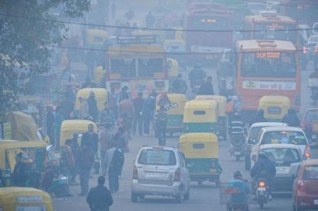 indian commuters travel on a polluted road near a bus terminus in the anand vihar district of new delhi on dec 18 2015 photo afp indian commuters travel on a polluted road near a bus terminus in the anand vihar district of new delhi on dec 18 2015 photo afp