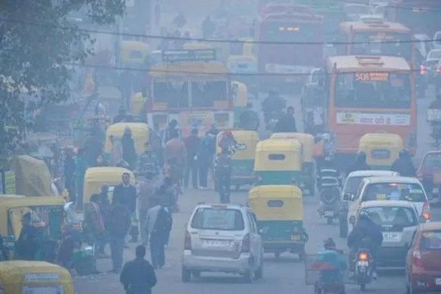 indian commuters travel on a polluted road near a bus terminus in the anand vihar district of new delhi on dec 18 2015 photo afp indian commuters travel on a polluted road near a bus terminus in the anand vihar district of new delhi on dec 18 2015 photo afp