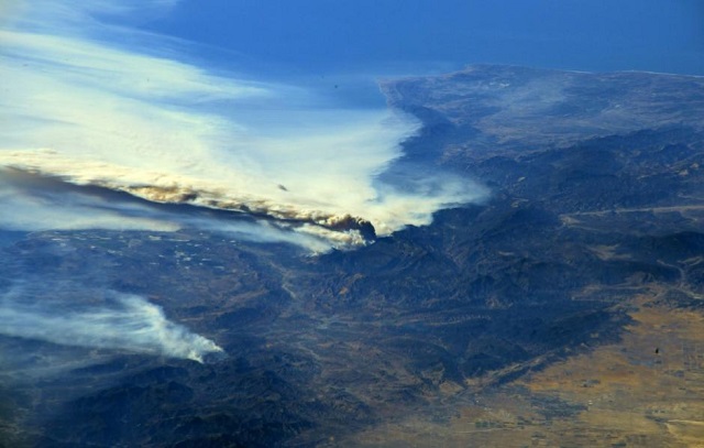 a photo taken from the international space station and moved on social media by astronaut randy bresnik shows smoke rising from wildfire burning in southern california u s december 6 2017 photo via reuters