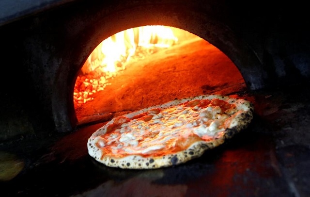 pizza margherita is prepared in a wood fired oven at l 039 antica pizzeria da michele in naples italy december 6 2017 photo reuters