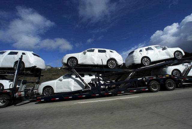 new vehicles covered in protective wrapping are shipped by a transport truck along interstate highway 5 north of san diego california us on january 7 2016 photo reuters