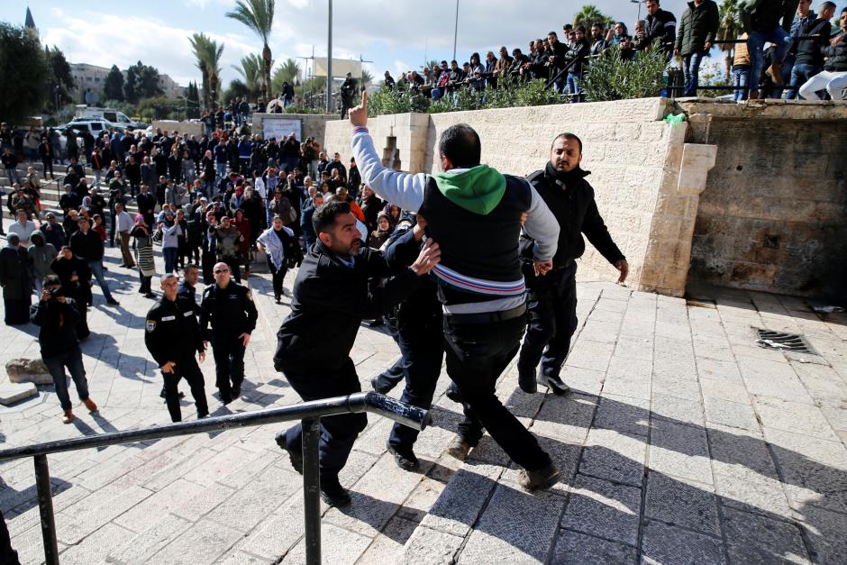 israeli policemen scuffle with a palestinian man during a protest following us president donald trump 039 s announcement that he has recognized jerusalem as israel 039 s capital near damascus gate in jerusalem 039 s old city photo reuters