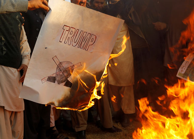 protesters burn a picture of us president donald trump at a protest following his announcement that he has recognised jerusalem as israel 039 s capital in islamabad pakistan photo reuters