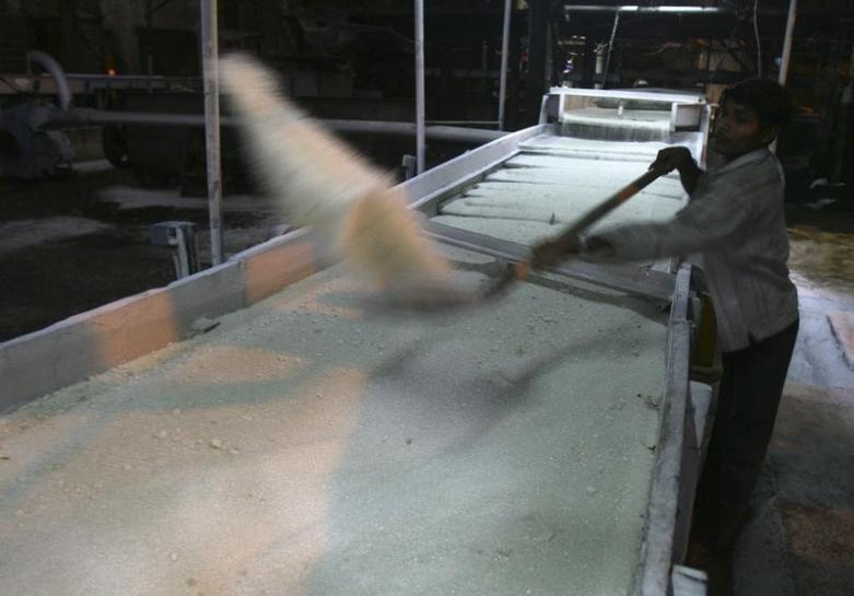 an employee works inside a sugar mill photo reuters