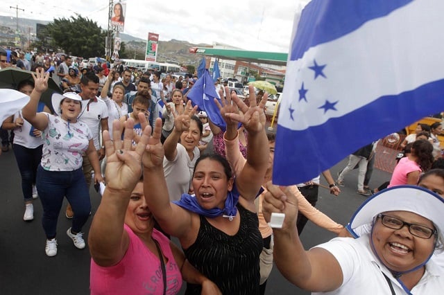 supporters of president and national party presidential candidate juan orlando hernandez gesture during a march in support of hernandez in tegucigalpa honduras december 7 2017 photo reuters