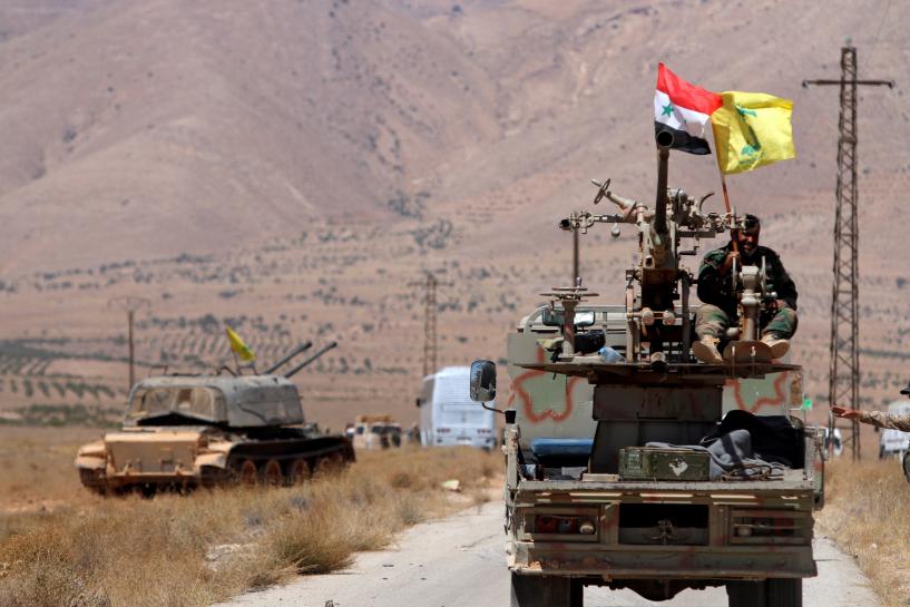 hezbollah and syrian flags flutter on a military vehicle in western qalamoun syria photo reuters