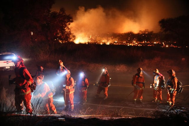 firefighters walk to the fire line at the lilac fire in bonsall california on december 7 2017 photo afp firefighters walk to the fire line at the lilac fire in bonsall california on december 7 2017 photo afp