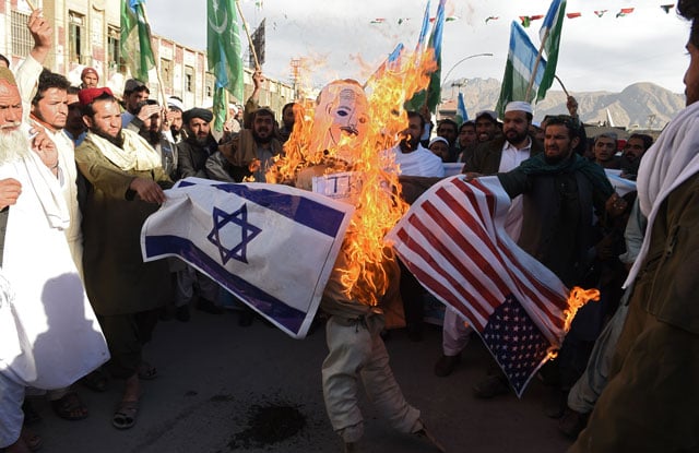 protesters burn an effigy depicting us president donald trump during an anti us and israel protest in quetta on december 8 2017 photo afp