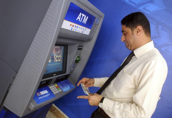 a man withdraws money from an atm machine photo reuters
