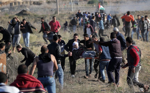 palestinian protesters carry a wounded young during a protest against us president decision to recognize jerusalem as the capital of israel during clashes along the border between israel and east gaza photo afp