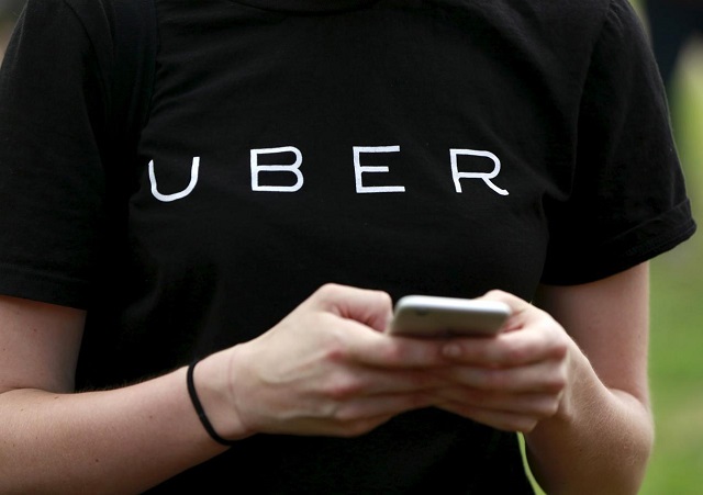 an uber representative registers people on his smartphone in the queens borough of new york july 21 2015 photo reuters