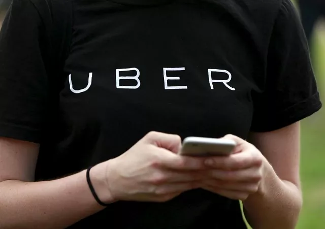 an uber representative registers people on his smartphone in the queens borough of new york july 21 2015 photo reuters an uber representative registers people on his smartphone in the queens borough of new york july 21 2015 photo reuters