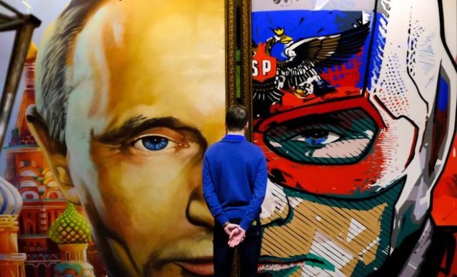 a man looks at a painting depicting russian president vladimir putin at the quot superputin quot exhibition at umam museum in moscow on december 6 2017 photo afp