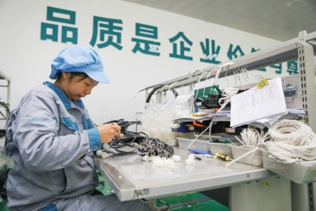 a woman working in a factory in jiangsu province china earlier this month photo afp
