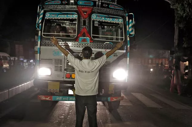 a member of the bhartiya gau raksha dal cow vigilante group raises his arms to stop a truck at a roadblock set up in the northern indian city of chandigarh in early july photo reuters a member of the bhartiya gau raksha dal cow vigilante group raises his arms to stop a truck at a roadblock set up in the northern indian city of chandigarh in early july photo reuters