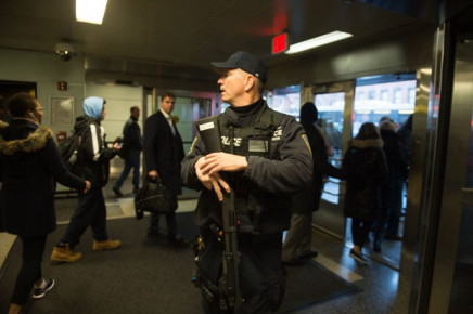 port authority police watch as people evacuate after a reported explosion at the port authority bus terminal on december 11 2017 in new york photo afp