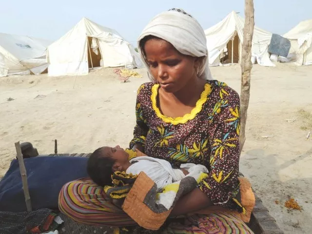 an internally displaced woman tends to her 10 day old baby born at a tent camp in sukkur photo afp an internally displaced woman tends to her 10 day old baby born at a tent camp in sukkur photo afp