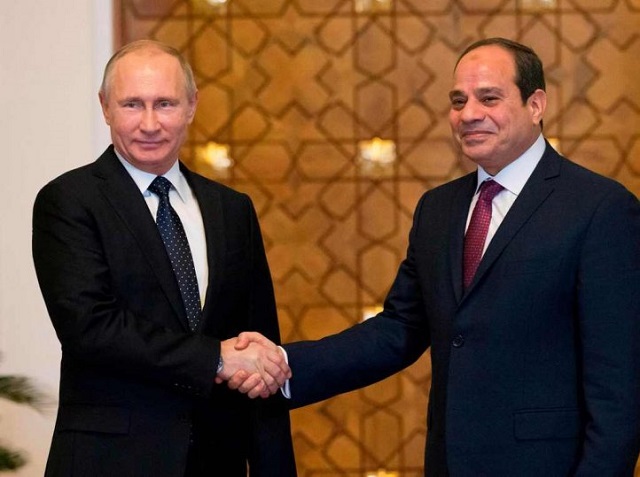 russian president vladimir putin l shakes hands with his egyptian counterpart abdel fattah al sisi upon his arrival at the presidential palace in the capital cairo on december 11 2017 photo afp