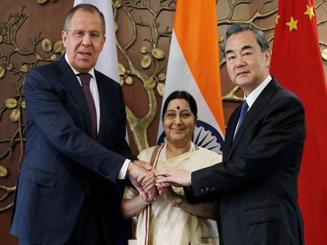 russian foreign minister sergei lavrov l indian foreign minister sushma swaraj c and chinese foreign minister wang yi shake hands before the start of their meeting in new delhi india december 11 2017 photo reuters
