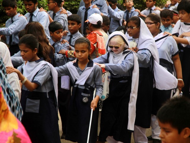 children from ida rieu school took part in the walk to raise awareness about the visually impaired photo athar khan express