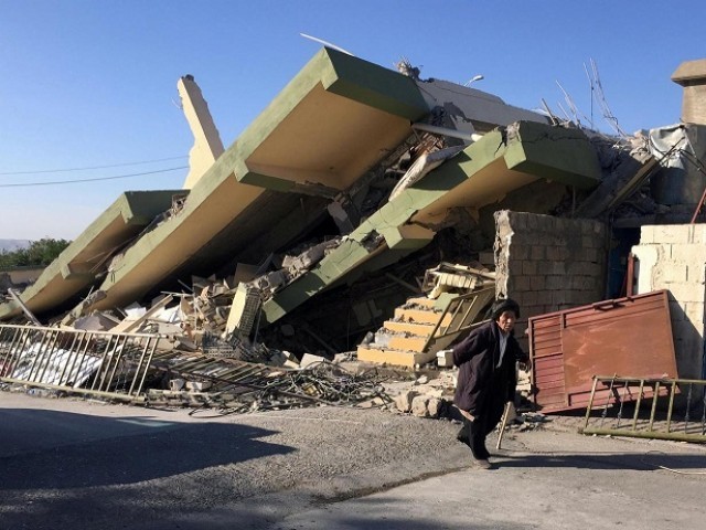 a man walks past a damaged building following an earthquake in darbandikhan in sulaimaniya governorate iraq november 13 2017 photo reuters