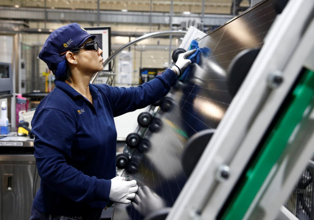 an employee makes a final inspection on panels photo reuters an employee makes a final inspection on panels photo reuters