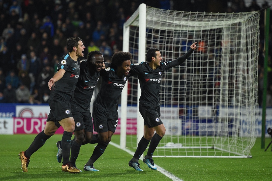 chelsea 039 s spanish midfielder pedro r celebrates with teammates after scoring their third goal during the english premier league football match between huddersfield town and chelsea at the john smith 039 s stadium in huddersfield northern england on december 12 2017 photo afp