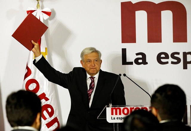 mexican presidential candidate andres manuel lopez obrador of the national regeneration movement morena shows a document during his registration as a pre candidate for morena for the july 2018 presidential election in mexico city mexico december 12 2017 photo reuters