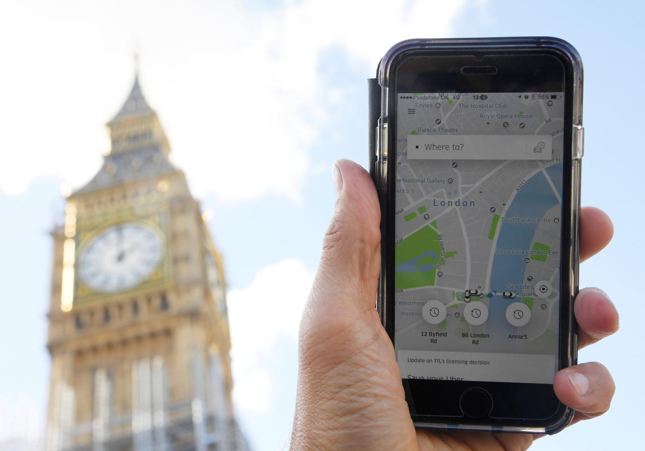 a photo illustration shows the uber app on a mobile telephone as it is held up for a posed photograph in central london britain photo reuters