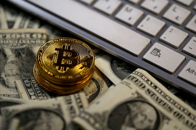 bitcoin coins placed on dollar banknotes next to computer keyboard are seen in this illustration picture november 6 2017 photo reuters