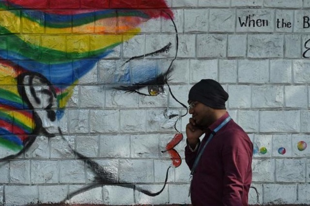 a man speaks walks past grafitti on female empowerment in mumbai on dec 14 2017 india 039 s minister for women has warned bollywood producers over sexual harassment in the hindi film industry photo afp