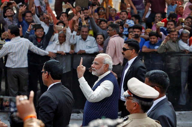 india 039 s prime minister narendra modi shows his ink marked finger after casting his vote outside a polling station during the last phase of gujarat state assembly election in ahmedabad india december 14 2017 photo reuters