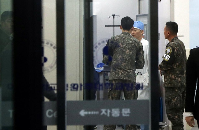 a south korean soldier talks with a surgeon at a hospital where a north korean soldier who defected to the south after being shot and wounded by the north korean military is hospitalized in suwon south korea photo via reuters