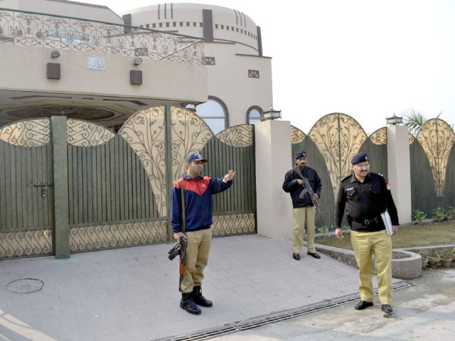 policemen stand guard outside the house where gunmen kidnapped a german aid worker and his italian colleague in multan photo afp policemen stand guard outside the house where gunmen kidnapped a german aid worker and his italian colleague in multan photo afp