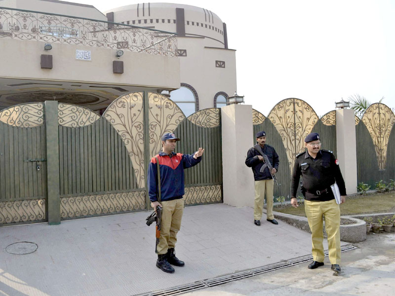 policemen stand guard outside the house where gunmen kidnapped a german aid worker and his italian colleague in multan photo afp