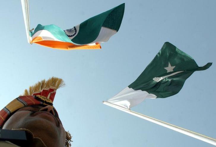 file photo an indian border guard stands near indian l and pakistani flags during a fair at chamliyal in jammu and kashmir june 22 2006 photo reuters