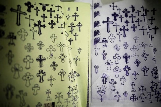 pages displaying different christian cross designs are seen at the studio of tattoo artist wassim razzouk who is continuing his family 039 s tradition of inking christian pilgrims with ancient tattoos in jerusalem 039 s old city november 27 2017 photo reuters pages displaying different christian cross designs are seen at the studio of tattoo artist wassim razzouk who is continuing his family 039 s tradition of inking christian pilgrims with ancient tattoos in jerusalem 039 s old city november 27 2017 photo reuters