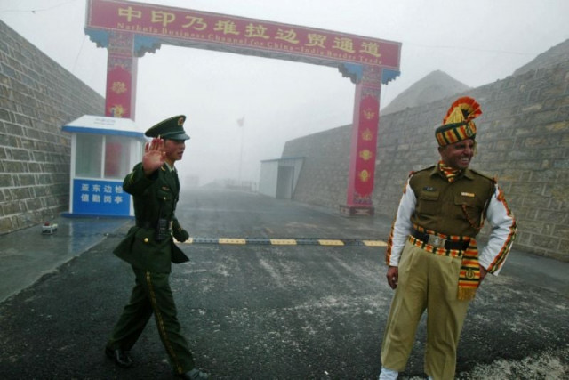 a chinese soldier and his indian counterpart at the ancient nathu la border crossing that remained closed for 44 years after the two asian countries fought a bitter war in 1962 photo afp a chinese soldier and his indian counterpart at the ancient nathu la border crossing that remained closed for 44 years after the two asian countries fought a bitter war in 1962 photo afp