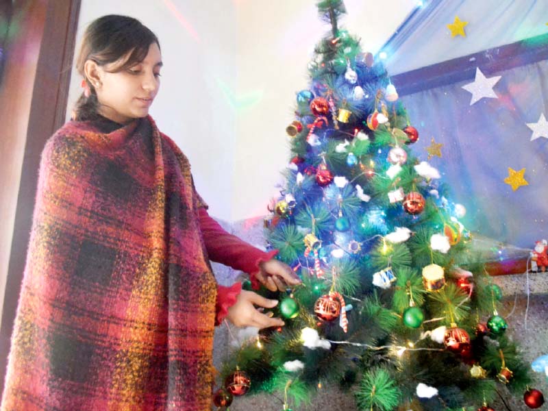 people decorate christmas trees and shop for the occasion photo express agencies