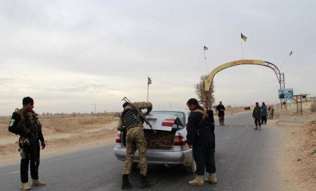 afghan police search passengers at a checkpoint in helmand photo afp afghan police search passengers at a checkpoint in helmand photo afp